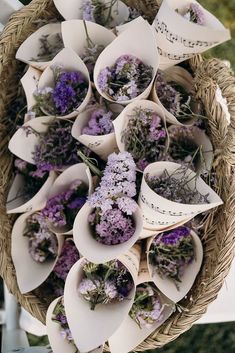 a basket filled with lots of purple flowers