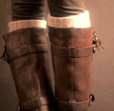 the legs of a person wearing brown boots