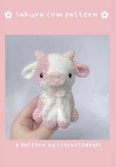 a pink and white crocheted stuffed animal in the shape of a cow is shown