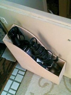 an open drawer with several cords in it