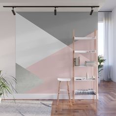 a living room with pink, grey and white geometric design wall mural on the wall