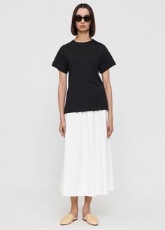 Totême tee in organic cotton. It’s designed for a regular fit and shaped to a fitted silhouette with a round neck, curved seams by the armholes adding structure to the sleeves, and a straight hem. The tee is finished with an in-tone monogram embroidery at the front. Wear in daytime over a skirt, denim or trousers. Classic Fitted Cotton T-shirt, Black Fitted Cotton T-shirt, Classic Fitted T-shirt For Spring, Fitted Minimalist Cotton T-shirt, Cotton Short Sleeve Tops With Minimal Stretch, Spring Classic Fitted T-shirt, Classic Fitted Spring T-shirt, Simple Fitted T-shirt For Everyday, Simple Everyday Fitted T-shirt