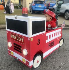 a small child in a fire truck costume