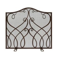 an iron fireplace screen with scroll designs