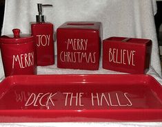 red bathroom accessories with merry christmas written on them