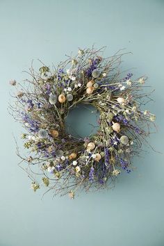 a wreath with dried flowers on a blue background