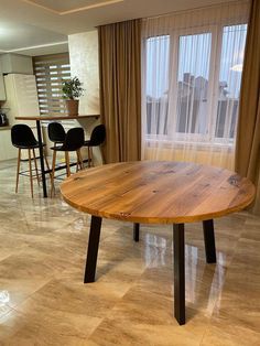 a wooden table sitting in the middle of a living room