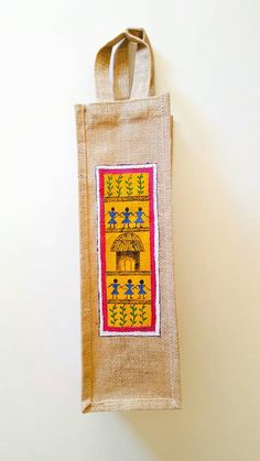 a jute bag hanging on the wall with an image of people holding umbrellas