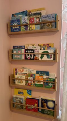 three wooden bookshelves are mounted to the wall in a child's room