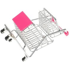 a miniature shopping cart with a pink book in the front and two black wheels on each side