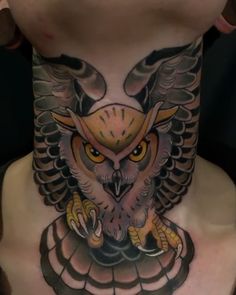 an owl tattoo on the back of a man's neck is shown in this image