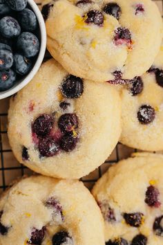 blueberries and lemons are piled up on a cooling rack