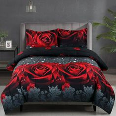 a bed with red and black roses on it