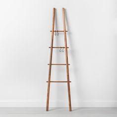 a wooden ladder leaning against a wall