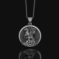 Silver Saint George Necklace - Patron Saint of Soldiers Pendant, Christian Religious Jewelry Gift, Personalized Gift Embrace the divine protection of our Saint George collection, a series of beautifully crafted spiritual and religious jewelry. Each piece, from the Patron Saint and Christian Pendant to the George Pendant and Silver Necklace, reflects profound faith and devotion. The Saint Medal and Saint Necklace are designed to inspire and uplift, making them perfect as a Religious Gift or a personal keepsake. Crafted from sterling silver, these Christian Jewelry pieces are not just adornments but symbols of faith that carry the legacy of Saint George as a guardian and protector. Ideal for anyone seeking a Spiritual Necklace that combines beauty with blessedness. ✦ Jewelry Details ✦ • Mate Mythological Engraved Pendant Jewelry, Mythological Style Engraved Pendant Jewelry, Mythological Silver Jewelry With Coin Pendant, Silver Mythological Jewelry With Coin Pendant, Mythological Engraved Round Pendant Jewelry, Mythological Medallion Jewelry Gift, Mythological Style Round Jewelry Gift, Symbolic Silver Medallion Necklace, Symbolic Silver Medallion Necklace Tarnish Resistant