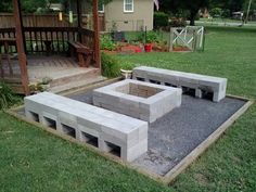 an outdoor fire pit made out of cinder blocks