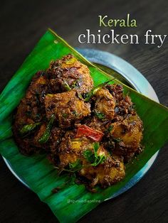 a close up of a plate of food on a table with the words kerala chicken fry