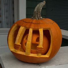 a carved pumpkin sitting on top of a porch