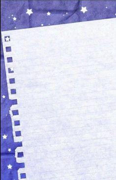 an open notebook with lined paper and stars on the cover is sitting in front of a blue background