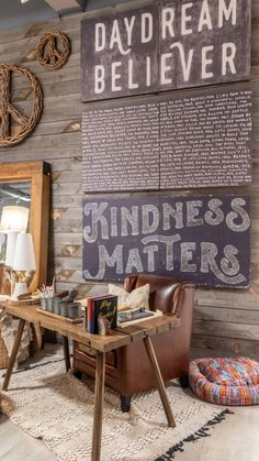 a living room filled with lots of furniture next to a wall covered in pictures and writing