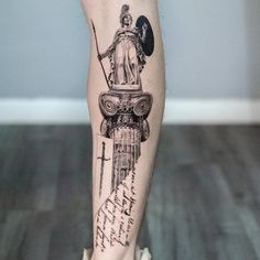 a man's leg with a statue on top of it and writing all over it