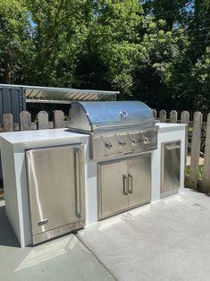 an outdoor kitchen with stainless steel appliances