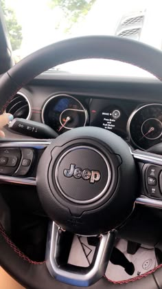 the interior of a car with steering wheel controls