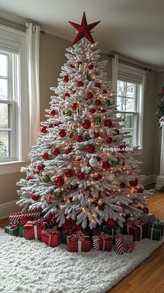 a white christmas tree with red and green ornaments