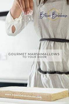 a woman is preparing marshmallows on a cutting board with the words, gourmet marshmallows to your door