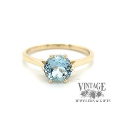 14 karat yellow gold aquamarine ring, angled front/side view Classic Topaz Birthstone Ring, 14k Gold Stamped Topaz Ring, Classic Blue Topaz Ring, 14k Gold Topaz Ring, Stamped 14k Gold Topaz Ring, Heirloom Round Topaz Ring Stamped 14k, Classic Topaz Ring With Round Cut, Heirloom Style Round Topaz Ring, Classic Blue Topaz Ring With Round Band