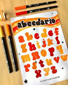 some markers and pencils are laying on top of a sheet of paper with the word abedaro written in it