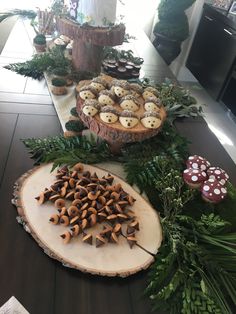 a table topped with lots of pastries on top of wooden slices