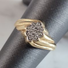 two gold rings sitting on top of each other