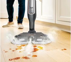 a person using a steam mop on the floor