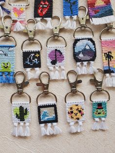 a bunch of key chains that have some pictures on them with tassels hanging from them