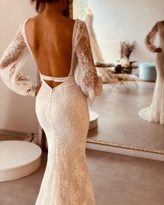 the back of a woman's dress in front of a mirror