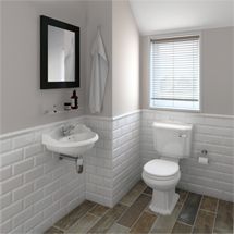 a white toilet sitting next to a sink in a bathroom under a mirror and a window