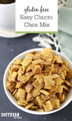 a bowl filled with chex mix next to a cup