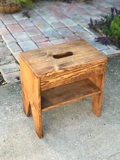 a small wooden table sitting on top of a sidewalk