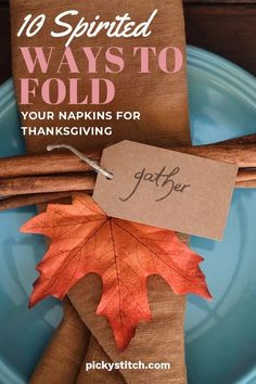 a blue plate topped with an orange leaf next to a tag that says 10 spirited ways to fold your napkins for thanksgiving