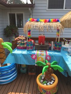 a table set up for a party with tiki decorations