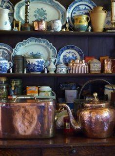 a shelf filled with lots of different types of dishes