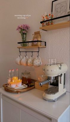 a coffee maker and some candles on a counter