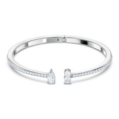 A classic look with geometric embellishments, this Swarovski Crystal bracelet boasts wear anywhere style. The rhodium plated cuff is adorned with sparkling crystals for a dazzling effect. One end of the cuff is punctuated with a pear cut crystal while the other end boasts a pair of round and square crystals. Stack this bracelet with other on-trend pieces to elevate your everyday look. This bracelet is a size large, 2 1/2 x 2 1/8 inches. Swarovski Crystal Style#: 5572664 Crystal Cuff Bracelet, Open Cuff Bracelet, Swarovski Crystal Bracelet, Swarovski Bracelet, Swarovski Jewelry, Cuff Bangles, Crystal Bracelets, Cute Jewelry, Rhodium Plated