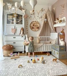 a child's bedroom with pink walls, white furniture and gold decorations on the ceiling