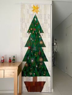 a christmas tree hanging on the wall next to a table