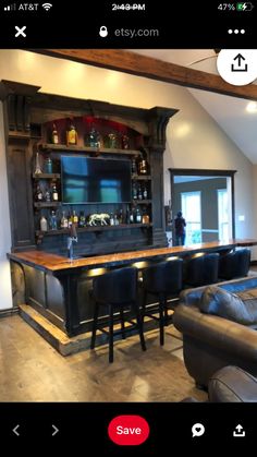 a living room filled with furniture and a bar