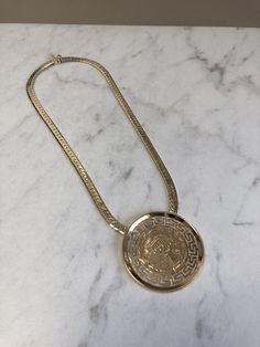 "METAL: 14kt and 18kt Solid Yellow Gold LENGTH: 16 inches WIDTH: 5mm WEIGHT: 30.4 grams CLOSURE: Hidden Box Clasp with Fig 8 safety closure. This custom-made Pendant has beautiful designs of Greek symbols on an 1 3/4\" diameter Disc Plaque. Chain is a 5mm Beveled Herringbone Chain in 16\". FREE SHIPPING Regular Retail Price: $4,789.00" Gold Plated Yellow Gold Herringbone Necklace With Box Chain, Formal Gold-tone Logo Plaque Necklace, Elegant Gold-plated Herringbone Necklace With Box Chain, Tarnish-resistant Yellow Gold-plated Herringbone Necklace, Classic Yellow Gold Herringbone Necklace, Tarnish Resistant, Greek Symbols, Greek Symbol, Italian Horn, Greek Design