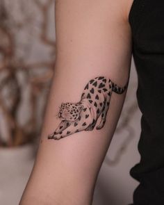 a black and white tattoo of a cheetah on the arm