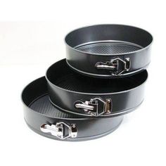 two black pans with handles on each side and one is holding an open lid